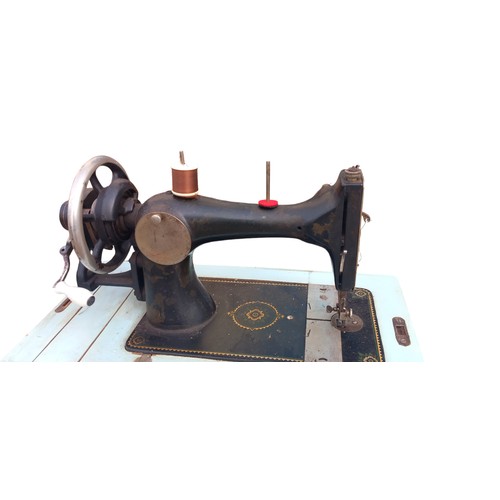 452 - A WOODEN CASED SEWING MACHINE WITH KEY