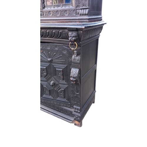 474 - A STUNNING ANTIQUE HEAVILY CARVED TALL IRISH BOOKCASE WITH STAINED GLASS PANELS DECORATIVLY CARVED W... 