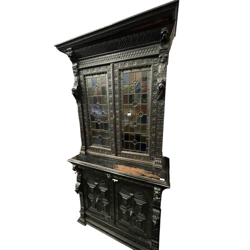 474 - A STUNNING ANTIQUE HEAVILY CARVED TALL IRISH BOOKCASE WITH STAINED GLASS PANELS DECORATIVLY CARVED W... 