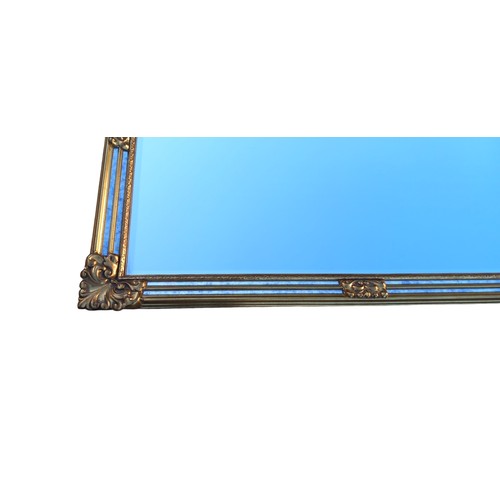 476 - AN ORNATE GILT FRAMED MIRROR