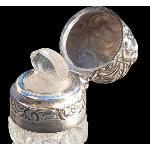 493 - A CUT GLASS PERFUME BOYYLE WITH GLASS STOPPER AND BIRMINGHAM SILVER TOP