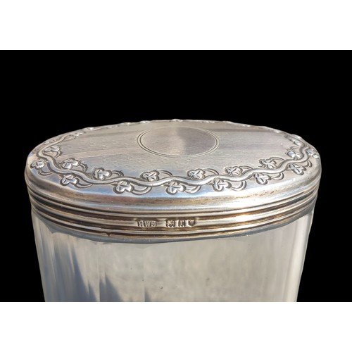 527 - A BIRMINGHAM SILVER TOPPED JAR EMBOSSED WITH SHAMROCKS