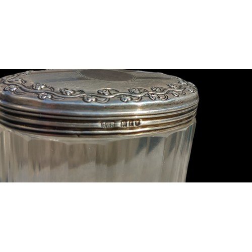 527 - A BIRMINGHAM SILVER TOPPED JAR EMBOSSED WITH SHAMROCKS