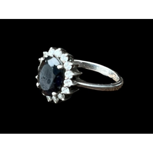 533 - A SILVER RING WITH SAPPHIRE AND CZ