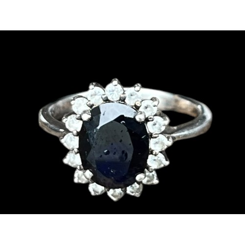 533 - A SILVER RING WITH SAPPHIRE AND CZ