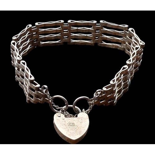 525 - A 4 BAR SILVER GATE BRACELET WITH A SILVER HEART LOCK