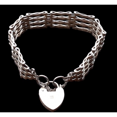 525 - A 4 BAR SILVER GATE BRACELET WITH A SILVER HEART LOCK