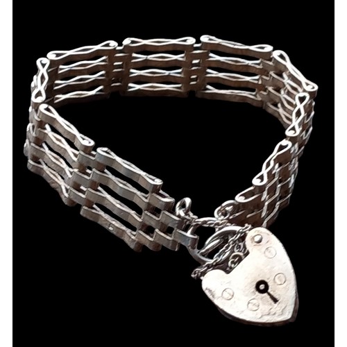 525 - A 4 BAR SILVER GATE BRACELET WITH A SILVER HEART LOCK