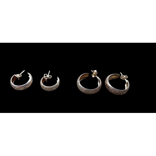 218 - A PAIR OF SILVER HALF HOOP EARRINGS