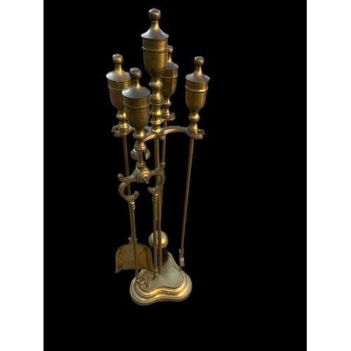 65 - A BRASS  COMPANION SET