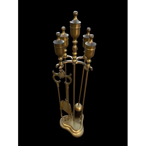 65 - A BRASS  COMPANION SET