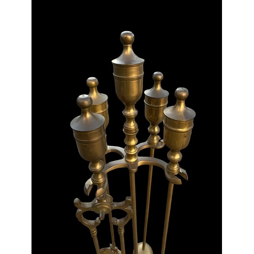 65 - A BRASS  COMPANION SET