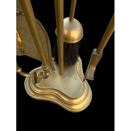 65 - A BRASS  COMPANION SET