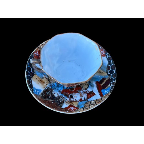 134 - AN ORIENTAL HAND PAINTED CUP AND SAUCER WITH MARKINGS TO THE BASE