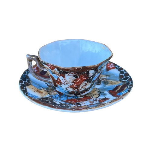 134 - AN ORIENTAL HAND PAINTED CUP AND SAUCER WITH MARKINGS TO THE BASE