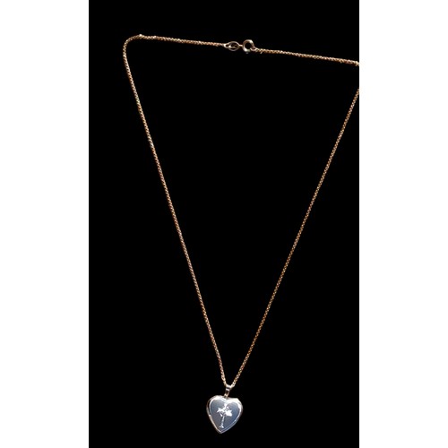 153 - A SILVER SATIN HEART WITH AN ETCHED CROSS ON SILVER CHAIN