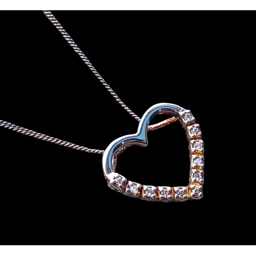 183 - A SILVER GEM SET HEART PENDANT ON A SILVER CHAIN