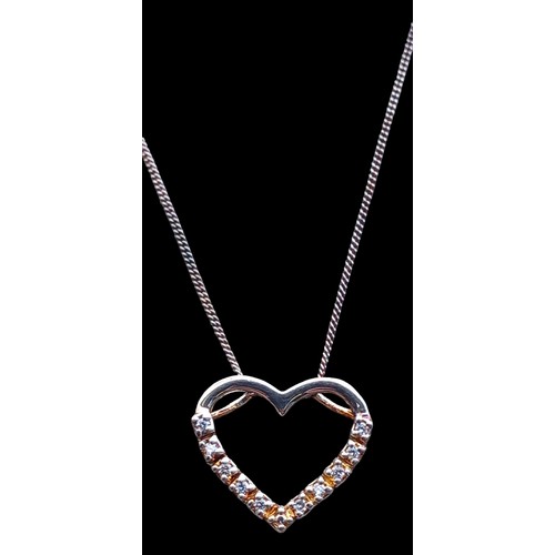 183 - A SILVER GEM SET HEART PENDANT ON A SILVER CHAIN