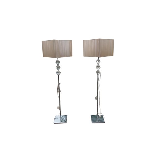 20 - A PAIR OF DESIGNER CHROME & GLASS STANDARD LAMPS