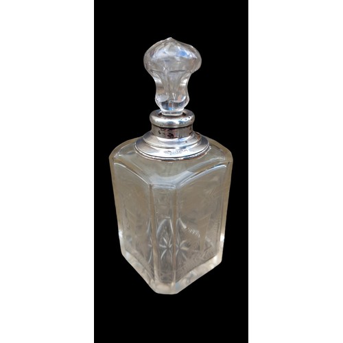 564 - AN ETCHED PERFUME BOTTLE WITH A SILVER TOP