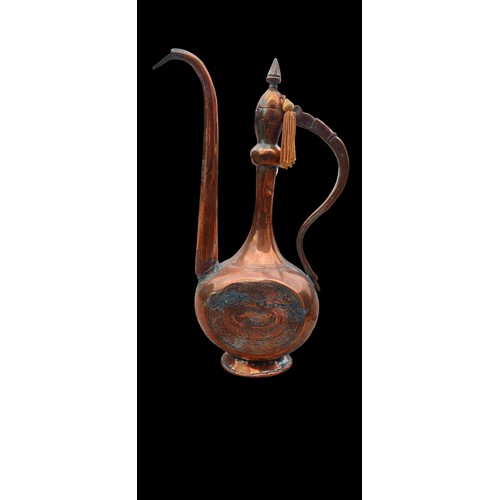 44 - AN ANTIQUE ISLAMIC ENGRAVED COPPER EWER/PITCHER