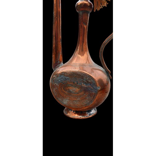 44 - AN ANTIQUE ISLAMIC ENGRAVED COPPER EWER/PITCHER