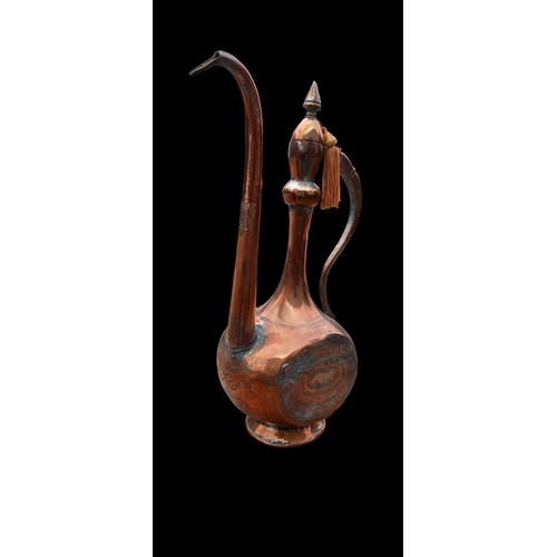 44 - AN ANTIQUE ISLAMIC ENGRAVED COPPER EWER/PITCHER