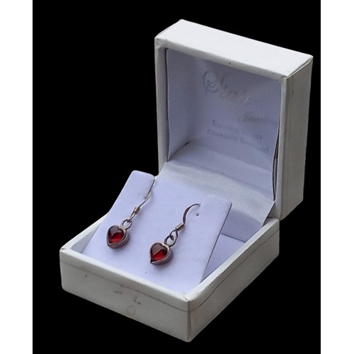 165 - A PAIR OF HEART SHAPED SILVER & GARNET EARRINGS