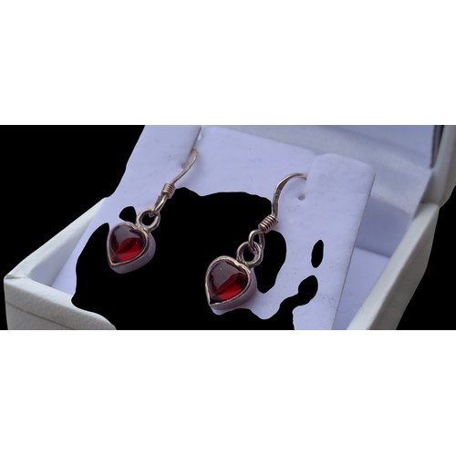 165 - A PAIR OF HEART SHAPED SILVER & GARNET EARRINGS