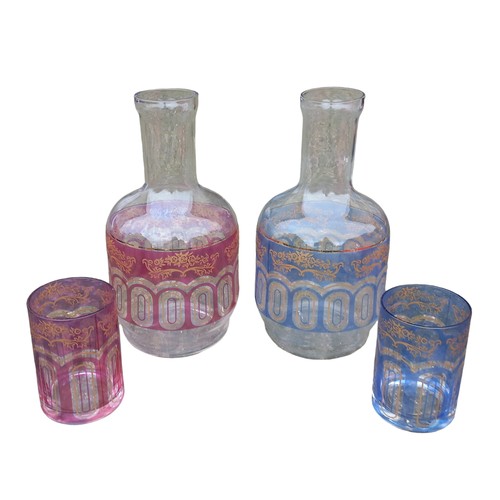 182 - A MIXED COLOUR PAIR OF CARAFES (FROM FULTONS)