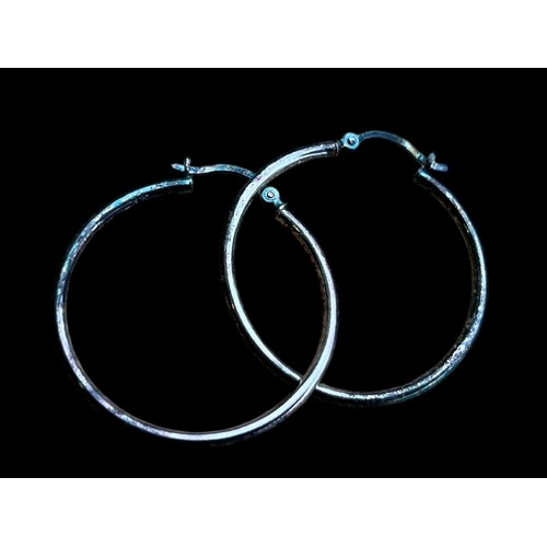 198 - A PAIR OF SILVER HOOP EARRINGS