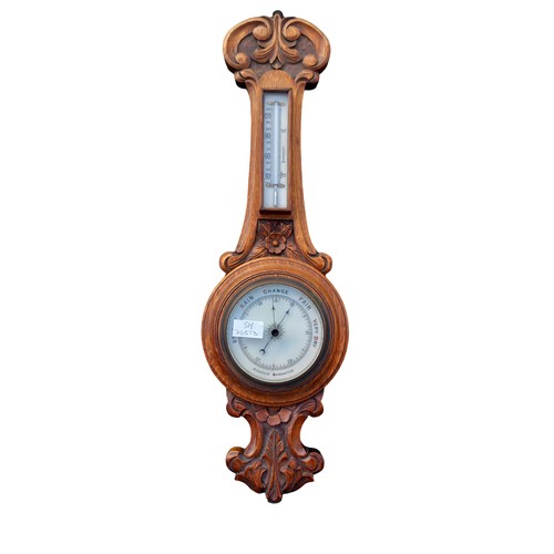 296 - A NICELY CARVED ANTIQUE OAK WALL BAROMETER (CRACKED GLASS)