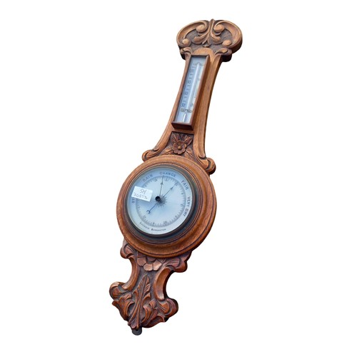 296 - A NICELY CARVED ANTIQUE OAK WALL BAROMETER (CRACKED GLASS)