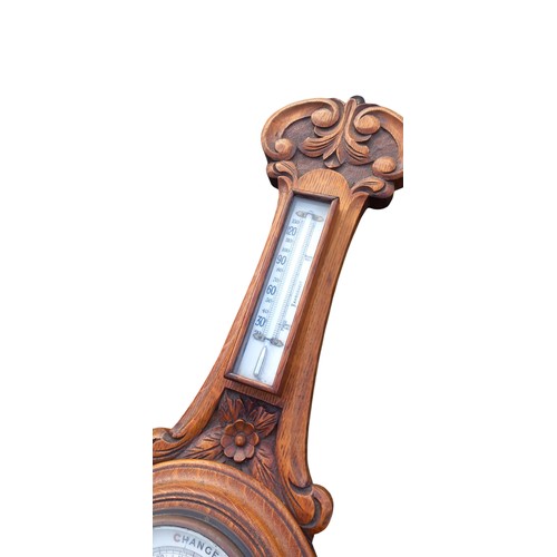 296 - A NICELY CARVED ANTIQUE OAK WALL BAROMETER (CRACKED GLASS)