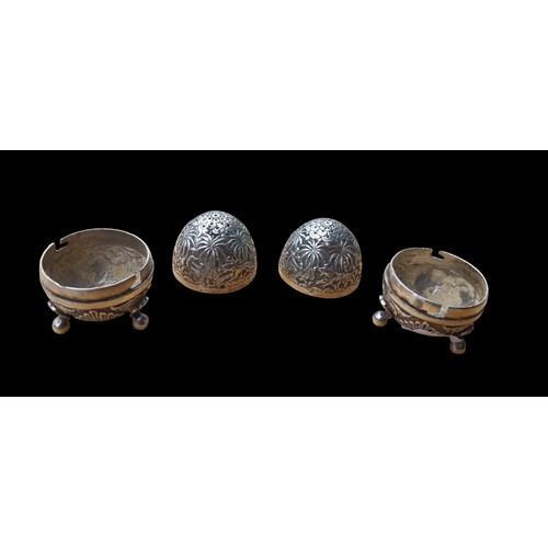 473 - A PAIR OF ORNATE EGG SHAPE CONDIMENTS ON TRIPOD FOOT