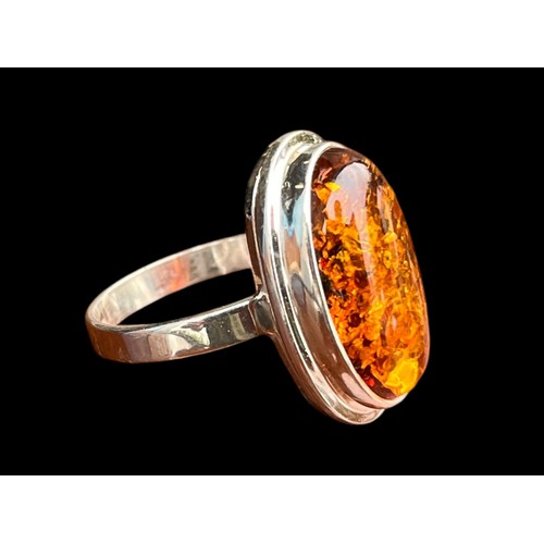 493 - A DESIGNER AMBER SILVER RING