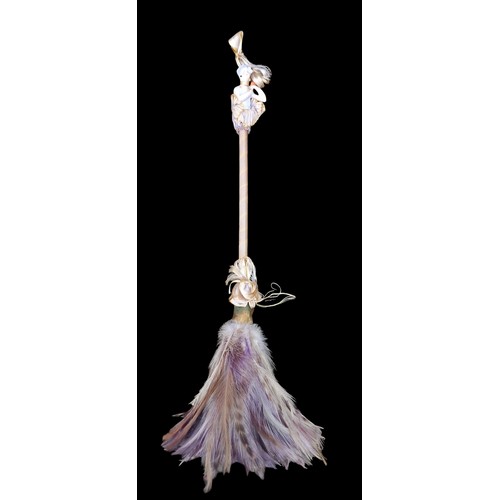 410 - AN UNUSUAL FEATHER DUSTER WITH A PORCELAIN FIGURED HANDLE