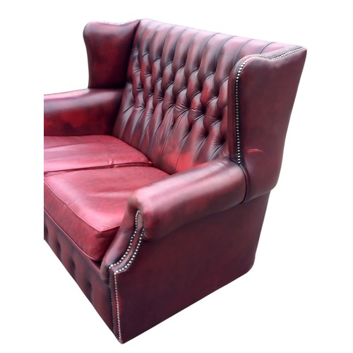 416 - A RED LEATHER BUTTONBACK 2 SEATER WINGBACK SETTEE