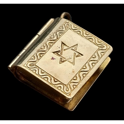 600 - A 9ct GOLD CHARM/PENDANT AS A RELIGIOUS BOOK WHICH OOPENS 2.16grm