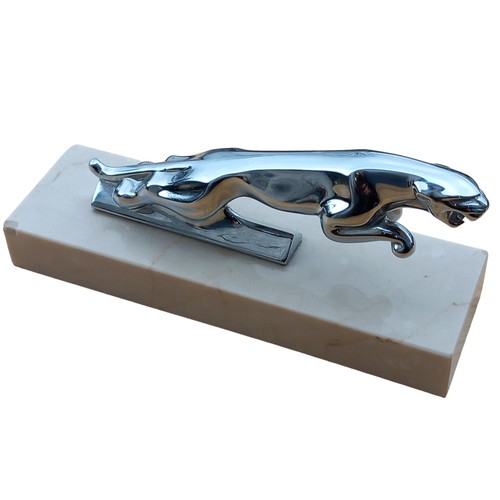 669 - A CHROME JAGUAR MASCOT ON A MARBLE PLINTH