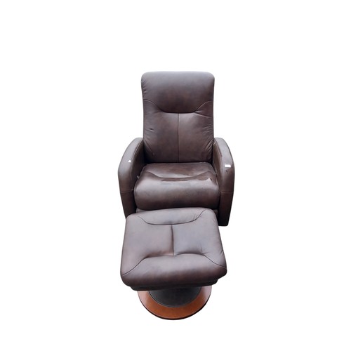 634 - A LAZY BOY BROWN LEATHER RECLINING ARMCHAIR AND MATCHING FOOTSTOOL