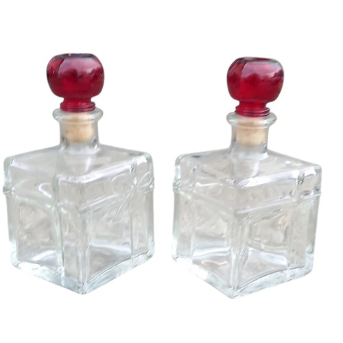 694 - 2 PERFUME BOTTLES WITH CRANBERRY GLASS TOPS