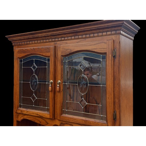 625A - A QUALITY HONEY OAK DRESSER WITH ETCHED BEVELLED GLASS DOORS