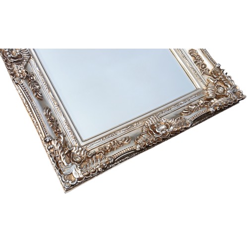 680C - A VERY ORNATE SILVER FRAMED MIRROR 35 x 46