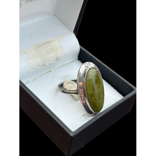 227 - AN IRISH SILVER RING SET WITH CONNEMARRA MARBLE