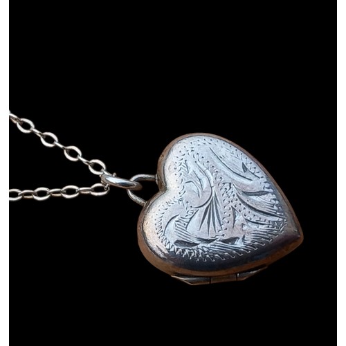 222 - A SILVER HEART LOCKET ON A SILVER CHAIN