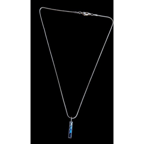 602 - A SILVER GEM SET BAR PENDANT ON A SILVER CHAIN