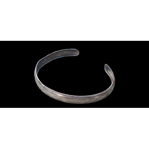 208 - AN ENGRAVED SILVER BANGLE