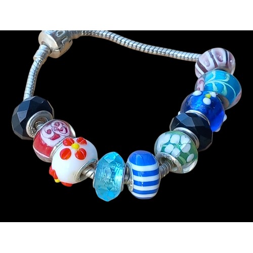 525 - A SILVER PANDORA BRACELET SET WITH 10 SILVER & MURANO STYLE CHARMS