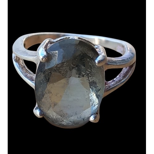 546 - A SILVER RING SET WITH AN UNUSAL STYLE STONE